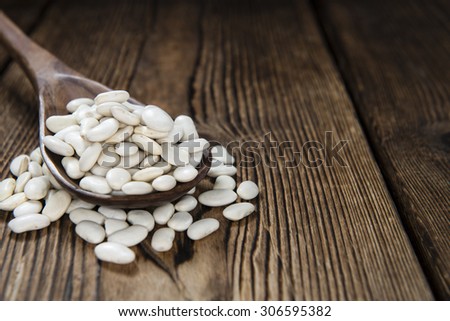 Portion of white beans (close-up shot) on rustic wooden background Stock foto © 