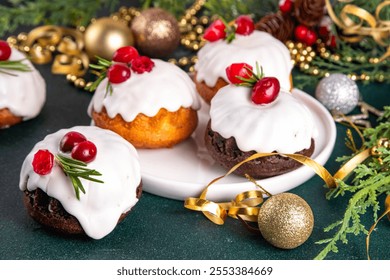 Portioned Christmas baked dessert, gingerbread chocolate and vanilla mini Christmas bundt cake with sugar glaze topping, cranberry and rosemary decor - Powered by Shutterstock