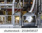 Portland Aerial Tram - modern slick design with rounded shapes mounted on the ropes with rollers stands at the lower station waiting for the lift time according to the timetable in Portland Oregon