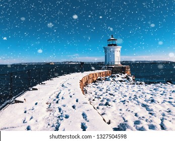 The Portland Breakwater Light (also called Bug Light) is a small lighthouse in South Portland, Maine,United States.The lighthouse winter view after snow with blue sky background.