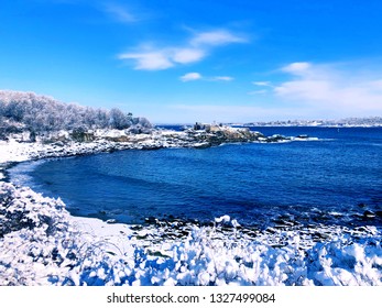 Portland Head Light Is A Historic Lighthouse In Cape Elizabeth, Maine,United States.The Lighthouse Winter View After Snow With Blue Sky Background.