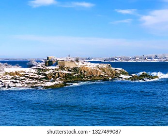 Portland Head Light Is A Historic Lighthouse In Cape Elizabeth, Maine,United States.The Lighthouse Winter View After Snow With Blue Sky Background.