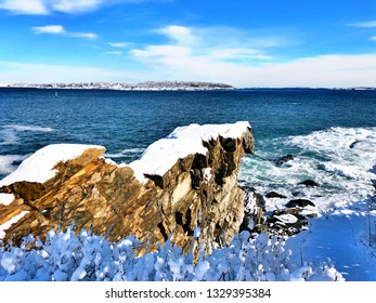 Portland Head Light Off Shore Waves Beating On The Rocks After Snow In New England Winter In Cape Elizabeth, Maine, United States.