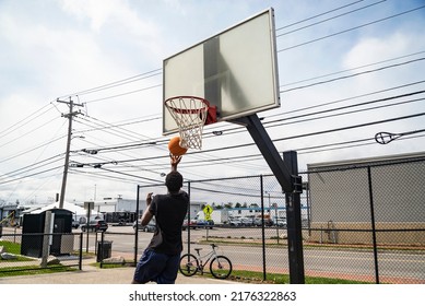 Portland, Maine -April 4, 2022: Cute Teenager Iplaying Basketball. Young Boy With Red Ball Shooting On The City Court. Hobby For Kids, Active Lifestyle. Portland Maine