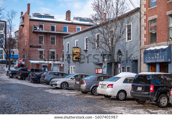 Portland, Maine - December 31\
2019: Historic cobble stone road on a winter day in Portland,\
Maine.
