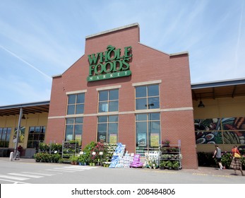 PORTLAND, MAINE - JUNE 1, 2014: Whole Food Market exterior and sign on a clear day. Whole Foods is an American foods supermarket chain specializing in natural and organic foods. 