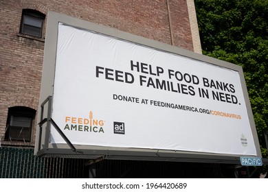 Portland, OR, USA - Apr 27, 2021: Feeding America billboard is seen in downtown Portland, Oregon, during the COVID pandemic. Feeding America is a nonprofit with a nationwide network of food banks.