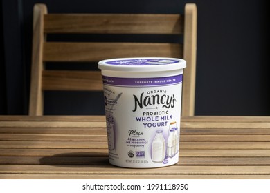 Portland, OR, USA - Apr 28, 2021: Closeup Of A Tub Of Nancy's Organic Whole Milk Yogurt On A Wooden Table. Nancy's Yogurt Is Produced By Springfield Creamery Based In Eugene, Oregon.