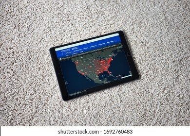 Portland, OR, USA - Apr 3, 2020: An iPad on bedroom carpet showing a live map of confirmed COVID-19 cases in United States Mainland created by researchers from CSSE at Johns Hopkins University.