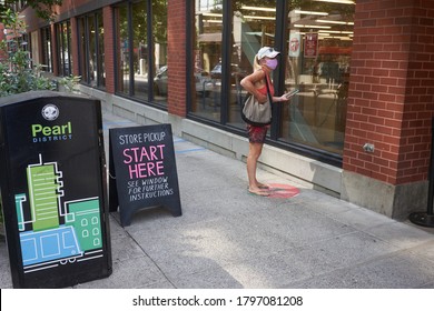 Portland, OR, USA - Aug 16, 2020: A Masked Shopper Waits Outside The Powell's Book Store In The Pearl District Of Portland, Oregon, For Store Pickup, During A Pandemic Summer.
