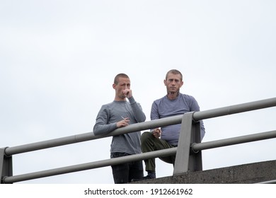 Portland, OR, USA - August 17 2019: Proud Boys, Patriot Prayer, And Other Far-right Groups Are Met By Counter-demonstrators Downtown. Young Bald Men In Matching Outfits Watch Menacingly From A Bridge.