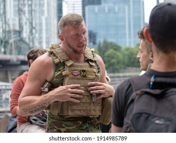 Portland, OR, USA - August 17 2019: Proud Boys, Patriot Prayer, And Other Far-right Groups Hold A Rally. A Very Tall Man In Tactical Gear And A Proud Boy Tattoo Talks To People In The Crowd.