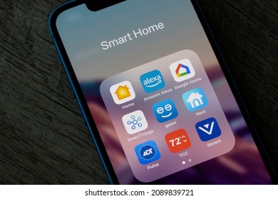 Portland, OR, USA - Dec 12, 2021: Assorted smart home apps are seen on an iPhone - Apple Home, Amazon Alexa, Google Home, SmartThings, Geeni, Nest, ADT Pulse, Honeywell Total Connect Comfort, Savant.