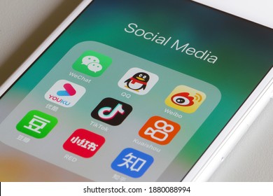 Portland, OR, USA - Dec 18, 2020: Assorted Chinese social media apps are seen on an iPhone, including WeChat, QQ, Weibo, Youku, TikTok, Kuaishou, Douban, Xiaohongshu, and Zhihu.