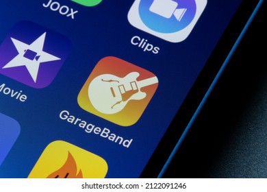 Portland, OR, USA - Feb 10, 2022: GarageBand mobile app icon is seen on an iPhone. GarageBand is a line of digital audio workstations that allows users to create music or podcasts.