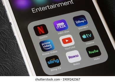Portland, OR, USA - Feb 2, 2021: Assorted streaming apps are seen on an iPhone, including Netflix, HBO Max, Disney Plus, Amazon Prime Video, YouTube, Apple TV, Sling TV, Roku, and Hulu.
