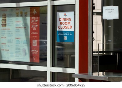 Portland, OR, USA - July 4, 2021: Dining Room Closed Sign Is Seen Next To The Order Pickup Window At A Burgerville Restaurant In Portland. Burgerville Is A Restaurant Chain Owned By The Holland Inc.