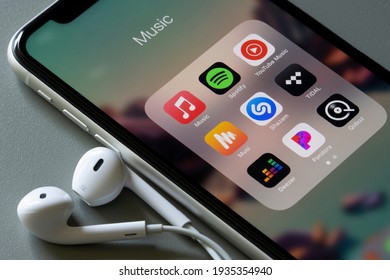 Portland, OR, USA - Mar 13, 2021: Assorted music apps are seen on an iPhone - Apple Music, Spotify, YouTube Music, Musi, Shazam, TIDAL, Deezer, Pandora, and Qobuz.