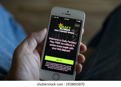 Portland, OR, USA - Mar 3, 2021: A Man Opens The DraftKings App From His IPhone. DraftKings Is An American Daily Fantasy Sports Contest And Sports Betting Operator.