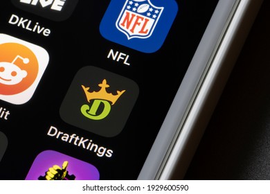 Portland, OR, USA - Mar 4, 2021: DraftKings app icon is seen on an iPhone. DraftKings is a digital sports entertainment and gaming company with products from daily fantasy, regulated gaming, to media.