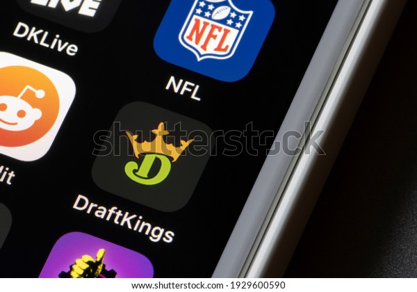 Portland, OR, USA - Mar 4, 2021: DraftKings app\
icon is seen on an iPhone. DraftKings is a digital sports\
entertainment and gaming company with products from daily fantasy,\
regulated gaming, to\
media.