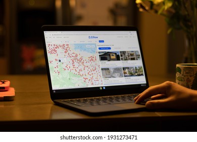Portland, OR, USA - Mar 7, 2021: A man searches for a single family home in the Bay Area from the Zillow website on his laptop at home. The U.S. is seeing the greatest housing price surge since 2006.