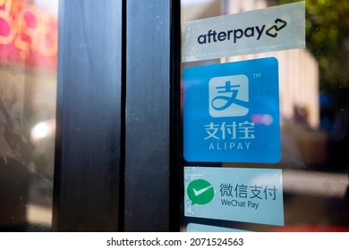 Portland, OR, USA - Nov 8, 2021: Door stickers advertising payment options including Alipay, WeChat Pay, and Afterpay, are seen at the entrance to the MAC Cosmetics in northwest Portland, Oregon.