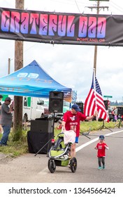 Portland, Oregon - 6/18/2016:  A Father And Son Cross The Finish Line In The 