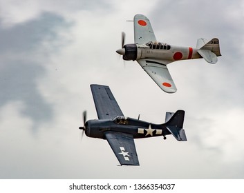 Portland, Oregon - 8/7/2016:   An A6M2 Japanese Zero flying with a US F6f Hellcat fighter aircraft at the Portland air show.