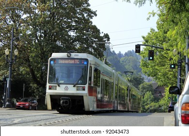 PORTLAND, OREGON - AUGUST 5: Public light rail train passing by during the day on August 5, 2010 in Portland, Oregon. There are 52.4 miles of light rail lines in the Portland metropolitan area.