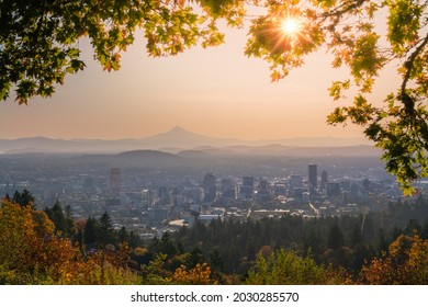 Portland Oregon Downtown in distance and Mt Hood with sunshine behind autumn foliage