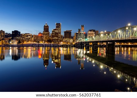 Portland Oregon downtown skyline along Willamette River during blue hour winter night scene