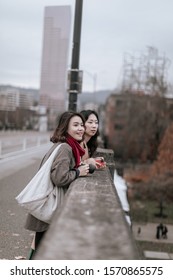 Portland, Oregon - Nov 16, 2019 : Two Asian Traveler Looking At William River On Burnside Bridge In Downtown Portland