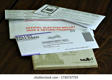 Portland, Oregon / United States - May 13, 2020: Voter Drops Off Mail In Ballot At An Official Election Ballot Drop Box.