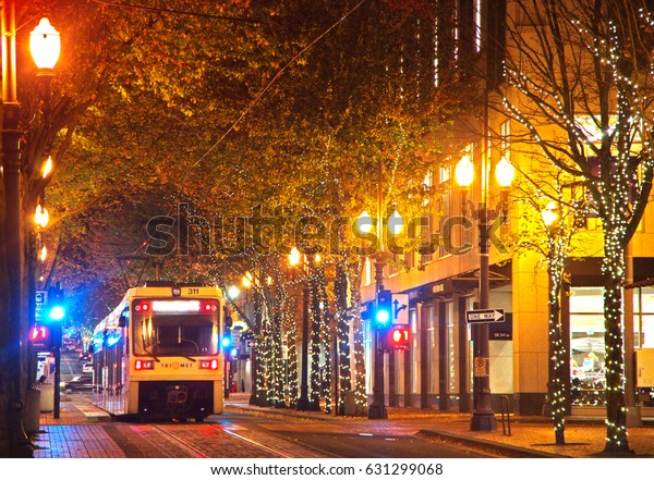 PORTLAND, OREGON, UNITED STATES - NOV 7, 2012: A\
light rail train running through the city of Portland OR at night.\
Editorial Use Only.
