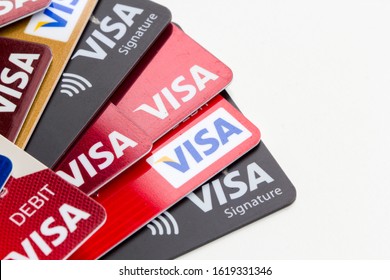 Portland, Oregon, USA - Jan 18, 2020: VISA credit cards and debit cards isolated on white.