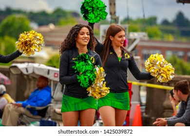 Portland, Oregon, USA - June 8, 2019: University or Oregon cheerleaders in the Grand Floral Parade, during Portland Rose Festival 2019.
