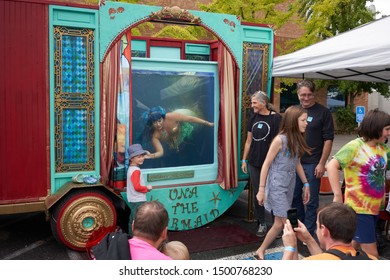 Portland, Oregon, USA - Sep 8, 2019: A Boy Has His Picture Taken With A Mermaid Entertainer At The Portland Mini Maker Faire.