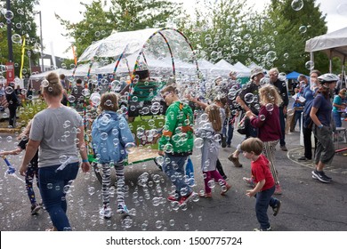 Portland, Oregon, USA - Sep 8, 2019: A Bubble Wagon Attracts Young Followers At The Portland Mini Maker Faire.