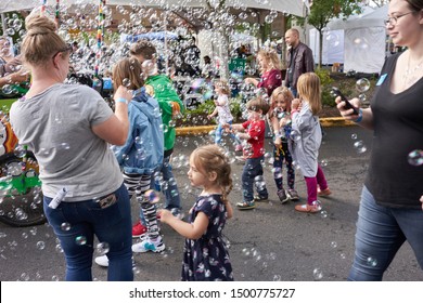 Portland, Oregon, USA - Sep 8, 2019: A Bubble Wagon Attracts Young Followers At The Portland Mini Maker Faire.