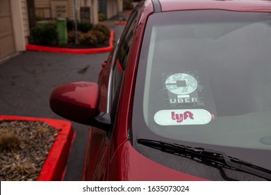 Portland, Oregon/USA-February 1, 2020: Lyft And Uber Signs On A Rideshare Vehicle On The Street