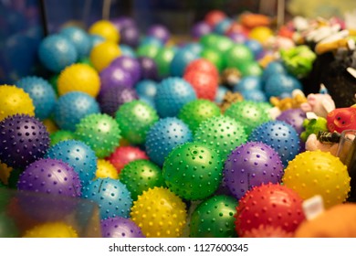 Portland, OR / USA - July 4 2018: Contents Of The Claw Machine In The Oaks Amusement Park. Piles Of Spiked Balls Of Different Colors.