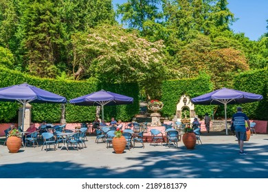 PORTMEIRION, WALES, UK - JULY 07 2022: Tourists enjoying a visit to Portmeirion in North Wales, designed and built by Sir Clough Williams-Ellis between 1925 and 1975 in the style of an Italian village