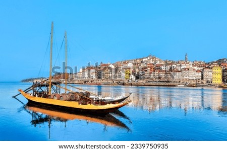 Porto cityscape skyline - Rabelo boat in Douro river at Oporto, Portugal.