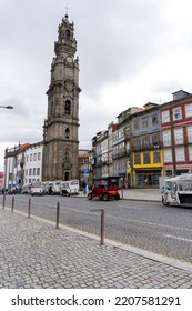 Porto, Portugal; 04 25 2022: Tower Of The Clérigos Church In Porto, Seen From Across The Street, With Parked Tourist Cars.