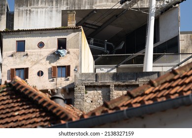 Porto, Portugal. 20 Feb 2022. Older Woman Hanging Laundry On Her Balcon.