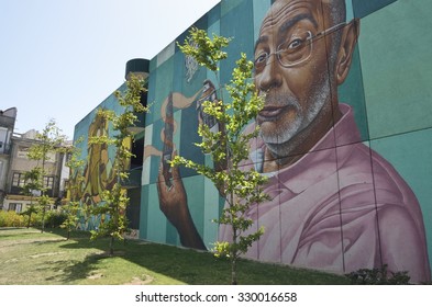 PORTO, PORTUGAL . AUGUST 10: Urban Graffitti Withe The Paint Of A Man On Wall In A Street In The Old Town In Porto, Portugal On August 10, 2015.