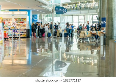 Porto / Portugal - August 18th, 2020: Passengers Waiting Inside Airport Waiting In Line For Boarding, Next To Gift Shop, Wearing Face Masks