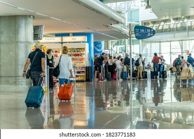 Porto / Portugal - August 18th, 2020: Passengers Waiting Inside Airport Waiting In Line For Boarding, Next To Gift Shop, Wearing Face Masks