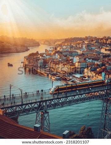 Porto, Portugal Dom Luis Iron Bridge at sunset featuring Douro River, Metro Train and Port Wine Boats